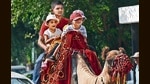 Children enjoying a camel ride near Sukhna Lake in Chandigarh on a sunny Sunday afternoon. The day temperature rose from 34.7°C the previous day to 34.9°C, 2 degrees above normal. (Keshav Singh/HT)