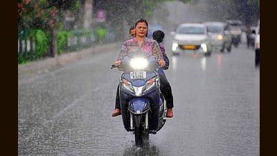 Commuters heading towards their destination during rain that hit some parts of the city in Ludhiana on Sunday, August 18, 2024. (Manish/HT)