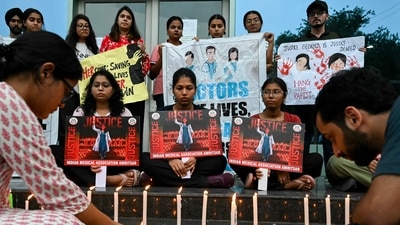 Medical professionals light candles as they pay tribute to a victim of the rape and murder of a young medic from Kolkata, in Amritsar on August 18, 2024. (Photo by Narinder NANU / AFP) (AFP) Medical professionals light candles as they pay tribute to a victim of the rape and murder of a young medic from Kolkata, in Amritsar on August 18, 2024. (Photo by Narinder NANU / AFP) (AFP)