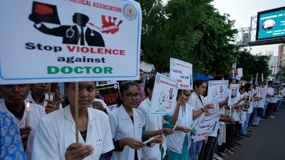 Kolkata rape-murder: Doctors and medical students hold placards and candles during a protest against the rape and killing of a trainee doctor at a government hospital. (AP) Kolkata rape-murder: Doctors and medical students hold placards and candles during a protest against the rape and killing of a trainee doctor at a government hospital. (AP)