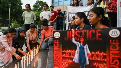 Medical professionals light candles as they pay tribute to a victim of the rape and murder of a young medic from Kolkata, in Amritsar on Sunday. (AFP)