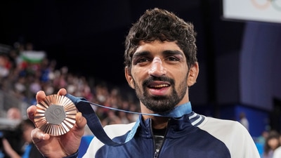 Paris: Bronze medalist India's Aman Sehrawat poses for photos during the victory ceremony for the men's 57kg free-style wrestling (PTI) Paris: Bronze medalist India's Aman Sehrawat poses for photos during the victory ceremony for the men's 57kg free-style wrestling (PTI)