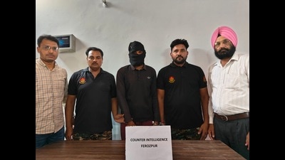 Sikander Singh (centre) after his arrest with the counter intelligence (CI) officers in Ferozepur district on Sunday