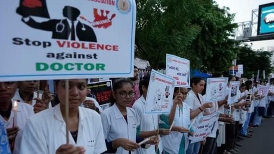 Rape and murder in Calcutta: Doctors and medical students hold up posters and candles during a protest (AP Photo)