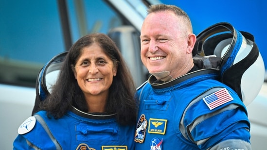 (FILES) NASA astronauts Butch Wilmore (R) and Suni Williams, wearing Boeing spacesuits, depart the Neil A. Armstrong Operations and Checkout Building at Kennedy Space Center for Launch Complex 41 at Cape Canaveral Space Force Station in Florida to board the Boeing CST-100 Starliner spacecraft for the Crew Flight Test launch, on June 5, 2024. (AFP)