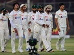 Pakistan's cricketers walk back to the pavilion at the end of the fifth and final day of the first Test match between Pakistan and New Zealand at the National Stadium in Karachi Pakistan's cricketers walk back to the pavilion at the end of the fifth and final day of the first Test match between Pakistan and New Zealand at the National Stadium in Karachi