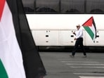 An Iranian man, carrying a Palestinian flag, walks to attend the funeral ceremony of Hamas leader Ismail Haniyeh and his bodyguard who were killed in an assassination blamed on Israel on Wednesday, at Enqelab-e-Eslami (Islamic Revolution) Sq. in Tehran, Iran, Thursday, Aug. 1, 2024. (AP Photo/Vahid Salemi)(AP) An Iranian man, carrying a Palestinian flag, walks to attend the funeral ceremony of Hamas leader Ismail Haniyeh and his bodyguard who were killed in an assassination blamed on Israel on Wednesday, at Enqelab-e-Eslami (Islamic Revolution) Sq. in Tehran, Iran, Thursday, Aug. 1, 2024. (AP Photo/Vahid Salemi)(AP)