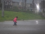 A man walks in a flooded street as Hurricane Beryl hits the southern coast of the island, in Kingston, Jamaica, July 3, 2024. (Marco Bello/Reuters)