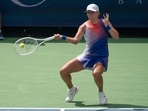 Iga Swiatek of Poland returns a shot during her match against Aryna Sabalenka.