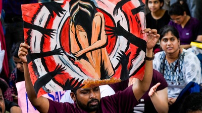 Doctors display a poster during a protest over the RG Kar Medical College incident, at Nirman Bhawan in New Delhi on Monday, (PTI)