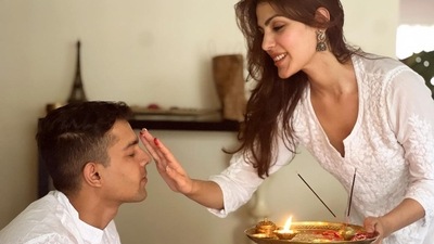 “My Forever Chapter,” wrote Rhea Chakraborty, sharing pictures of her tying her brother Showik Rakhi on Raksha Bandhan. She also shared happy pictures of her hugging and feeling him ladoo. 