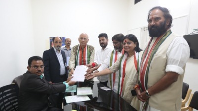Singhvi submitting his papers to returning officer Upender Reddy. (Sourced)
