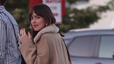 Dakota Johson showing her engagement ring