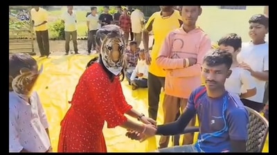 The woman can be seen in a tiger mask celebrating Rakhsha Bandhan, The woman can be seen in a tiger mask celebrating Rakhsha Bandhan,