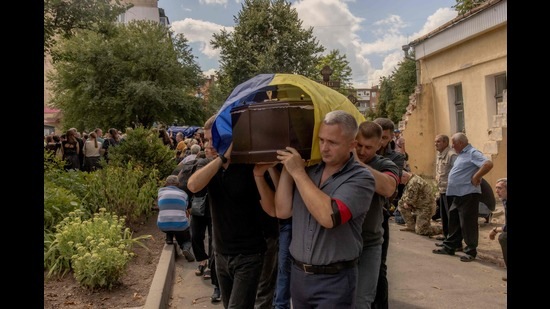 Men carry a coffin during the funeral of six Ukrainian servicemen, who were killed since Ukraine launched its offensive at the Russian border region of Kursk, in Sumy, northeastern Ukraine, on August 15. (AFP)