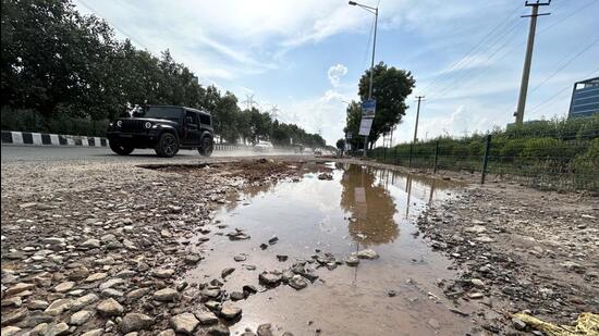 The pothole-riddled Southern Peripheral Road near Gurugram Sector 74A on Monday. (Parveen Kumar/HT Photo)