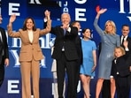 Joe Biden holds US Vice President and 2024 Democratic presidential candidate Kamala Harris hand after delivering the keynote address, as the Biden family stands alongside, on the first day of the Democratic National Convention (DNC) at the United Center in Chicago, Illinois, on August 19, 2024. 