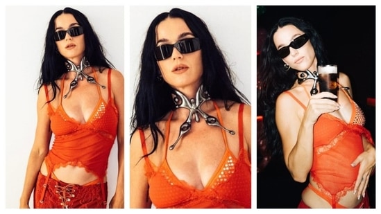 Katy Perry stunned in this sci-fi, futuristic look. She wore a bright-orange, semi-sheer camisole top with a deep neckline. Tiny silver sequins embellish the top's neckline. The top's hemline has a lacy hemline, adding a delicate touch to the fiery outfit. The singer donned a matching orange pant with a corset-like lace up at the front. Her neckpiece was the statement of her entire ensemble, a large, metallic choker in the shape of a butterfly. The big, rectangular-framed sunglass imparted an air of mystery to her loud ensemble.(Instagram/@katyperry)