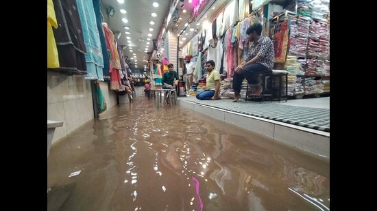 Members of the association, troubled by this constant inconvenience, had collectively contributed to install a pressure pump, which could pull out water from the storage tank and make space for more water to avoid logging in the market. (Keshav Singh/HT)