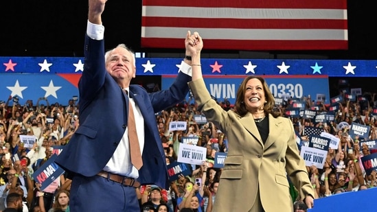 Minnesota Governor and Democratic vice presidential candidate Tim Walz (L) gestures alongside US Vice President and Democratic presidential candidate Kamala Harris during a campaign event at Desert Diamond Arena in Glendale, Arizona, on August 9, 2024. (Photo by Robyn Beck / AFP)(AFP)