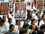 Medical professionals hold posters at a hospital in Bengaluru amid nationwide strike by doctors to condemn the rape and murder of a young medic from Kolkata.