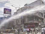 Patna: Police personnel use water cannon to disperse people protesting during the 'Bharat Bandh' called by SC/ST organisations over reservation issue, in Patna, Wednesday, Aug. 21, 2024. (PTI Photo)