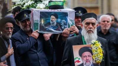 A member of a honour guards weeps while carrying the coffin of Iran's President Ebrahim Raisi during a funeral procession in Qom. (AFP)