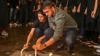 Kolkata: Former cricketer Sourav Ganguly along with his daughter Sana Ganguly lights candles to pay tribute and protest against the alleged sexual assault and murder of a postgraduate trainee doctor, in Kolkata, Wednesday, Aug. 21, 2024. (PTI) Kolkata: Former cricketer Sourav Ganguly along with his daughter Sana Ganguly lights candles to pay tribute and protest against the alleged sexual assault and murder of a postgraduate trainee doctor, in Kolkata, Wednesday, Aug. 21, 2024. (PTI)