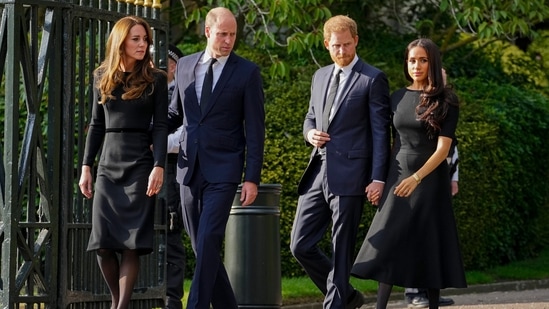 Britain's Prince William, second left, Kate, Princess of Wales, left, Britain's Prince Harry, second right, and Meghan, Duchess of Sussex view the floral tributes for the late Queen Elizabeth II outside Windsor Castle, in Windsor, England on Sept. 10, 2022. (AP Photo/Martin Meissner, File)(AP)