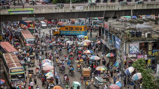 Commuters ride along a street in Old Dhaka, Bangladesh on August 17. (AFP)