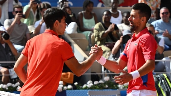 Novak Djokovic of Serbia (R) shakes hands with Carlos Alcaraz of Spain (L).(EPA-EFE)