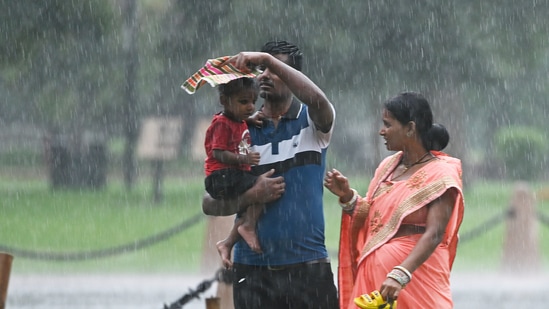 Visitors at Kartavya Path amid monsoon rain in New Delhi, India. (Photo by Sanjeev Verma/Hindustan Times)