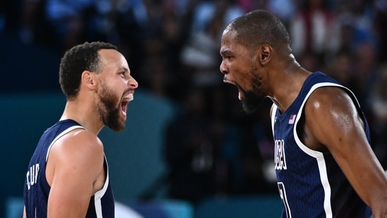 TOPSHOT - USA's #04 Stephen Curry (L) and USA's #07 Kevin Durant celebrates after scoring in the men's Gold Medal basketball match between France and USA during the Paris 2024 Olympic Games at the Bercy Arena in Paris on August 10, 2024.(AFP)