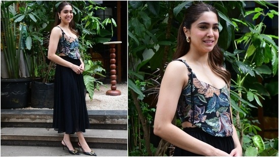 Sharvari Wagh wears a floral corset blouse and a pleated black ruffle midi skirt for an outing. She styled the elegant ensemble with gold hoop earrings, kitten heels by Valentino, centre-parted half-tie hairdo, nude lips, striking eye makeup, and rouge-tinted cheeks.&nbsp;(HT Photo/Varinder Chawla)