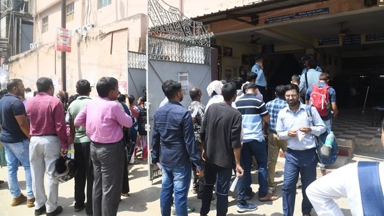 Students have to undergo a mandatory frisking process before entering the exam hall. They must bring their admit cards along with a photo ID to get entry inside the exam hall. (Photo by Santosh Kumar)