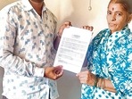 Sunanda Balu More and her son Sagar More holding bank account statement. (HT PHOTO)