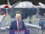 Donald Trump speaks from a bulletproof glass housing during a campaign rally, at the North Carolina Aviation Museum & Hall of Fame in Asheboro, North Carolina, U.S. August 21, 2024. REUTERS/Jonathan Drake     TPX IMAGES OF THE DAY