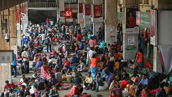 Stranded passengers gather at a railway station while waiting for their trains after heavy rains in Chennai on December 6, 2023. Chest-high water surged down the streets of India's southern city Chennai on December 5, with eight people killed in intense floods as Cyclone Michaung made landfall on the southeast coast. (Photo by AFP)