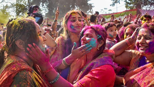 People play with colours to celebrate the festival of Holi, in Gorakhpur