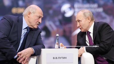 In this photo released by Roscongress Foundation, Russian President Vladimir Putin, right, and Belarusian President Alexander Lukashenko 