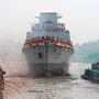 Confetti and smoke in the colors of the Indian national flag mark the entry of INS Vindhyagiri, a new warship for the Indian navy, into the Hooghly river in Kolkata, India, Thursday, Aug. 17, 2023. This P17A series warship, built by the Garden Reach Shipbuilders and Engineers in Kolkata, was launched by the Indian President Droupadi Murmu Thursday. (AP Photo/Bikas Das)