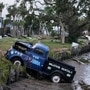 Pick up trucks and debris lie strewn in a canal in Horseshoe Beach in Florida after the passage of Hurricane Idalia