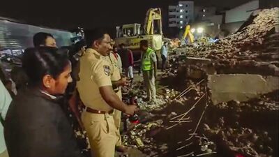 Hyderabad: Police at the site after a retaining wall at an under construction apartment collapsed due to heavy rains in Bachupally area, in Hyderabad, Tuesday night. 