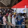 Voters in Mumbai city queue up to cast their ballots at a polling station during the fifth phase of voting on May 20, 2024. 