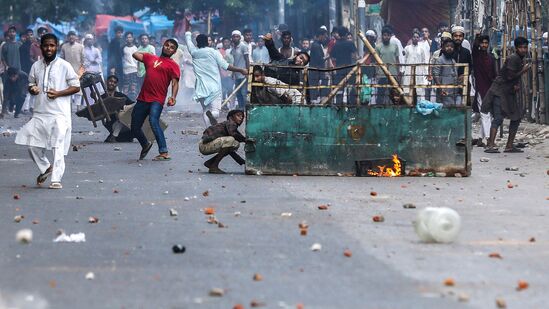 Protesters pelt stones as they clash with police during the ongoing anti-quota protest in Dhaka