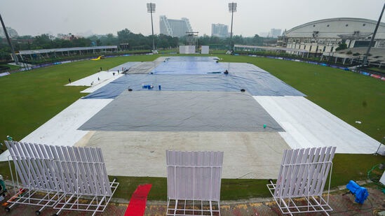 Greater Noida: Groundsmen cover the Greater Noida Sports Complex ground during rains on the eve of the one-off Test cricket match between New Zealand and Afghanistan, in Greater Noida, Sunday, Sept. 8, 2024. (PTI Photo/Kamal Kishore) (PTI09_08_2024_000130B)
