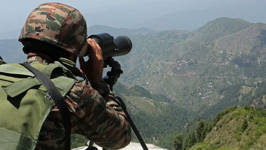 An Indian army soldier uses binoculars to keep vigil near the Line of Control (LoC) between Pakistan and India, in Poonch sector of India's Jammu region, on May 20, 2025. (Photo by Mukesh GUPTA / AFP)