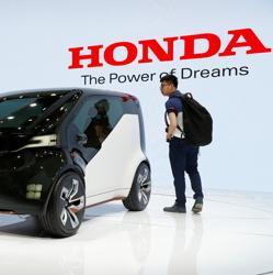 People gather around a Honda concept car displayed at Shanghai Auto Show during its media day. People gather around a Honda concept car displayed at Shanghai Auto Show during its media day.