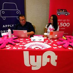 Recruiters for Lyft wait for the opening of a job fair in Golden, Colorado. Recruiters for Lyft wait for the opening of a job fair in Golden, Colorado.
