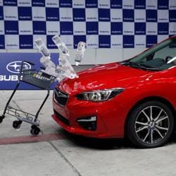 Subaru's new XV hits a shopping cart carrying water bottles during a collision test demonstration at its factory in Ota, north of Tokyo, Japan.